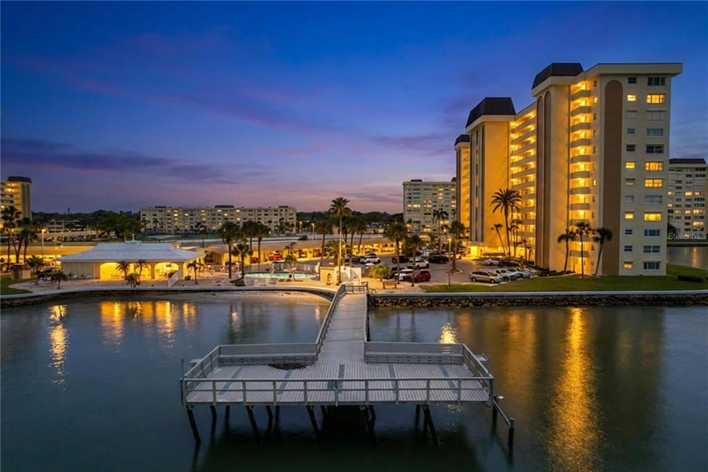 4650 Cove Circle, Unit 209 St. Petersburg, FL 33708 - Photo 51 of 54 a view of a swimming pool with lounge chair