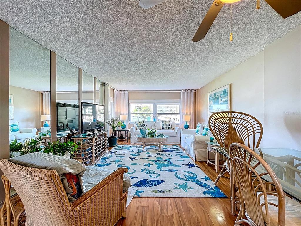 4650 Cove Circle, Unit 209 St. Petersburg, FL 33708 - Photo 6 of 54 a living room with furniture fireplace and a table