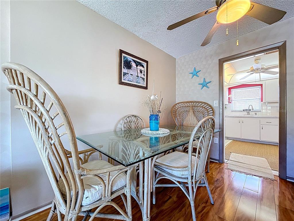 4650 Cove Circle, Unit 209 St. Petersburg, FL 33708 - Photo 8 of 54 a view of a dining room with furniture and chandelier