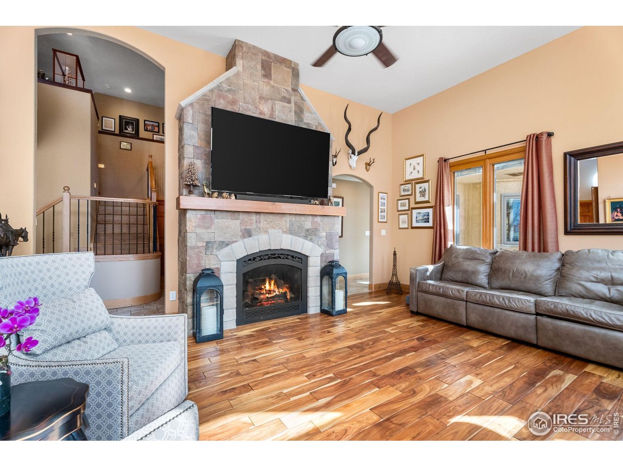 12625 Vermillion Road Longmont, CO 80504 - Photo 16 of 50 a living room with furniture a flat screen tv and a fireplace