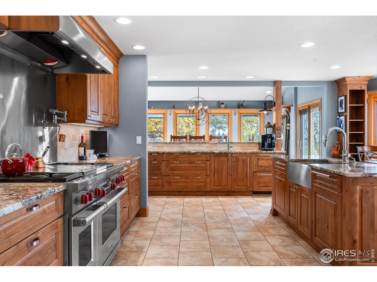 12625 Vermillion Road Longmont, CO 80504 - Photo 21 of 50 a kitchen with stainless steel appliances granite countertop a stove a sink and a refrigerator