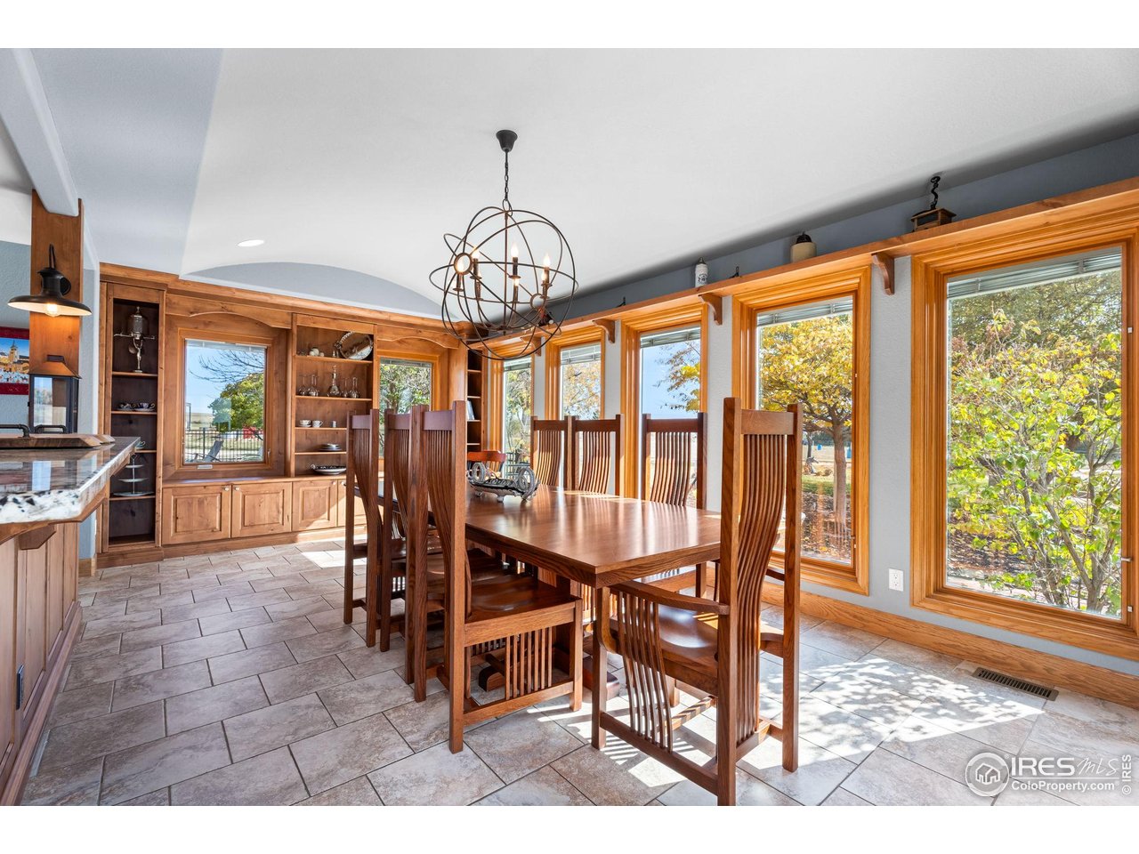 12625 Vermillion Road Longmont, CO 80504 - Photo 22 of 50 a view of a dining room with furniture wooden floor and chandelier