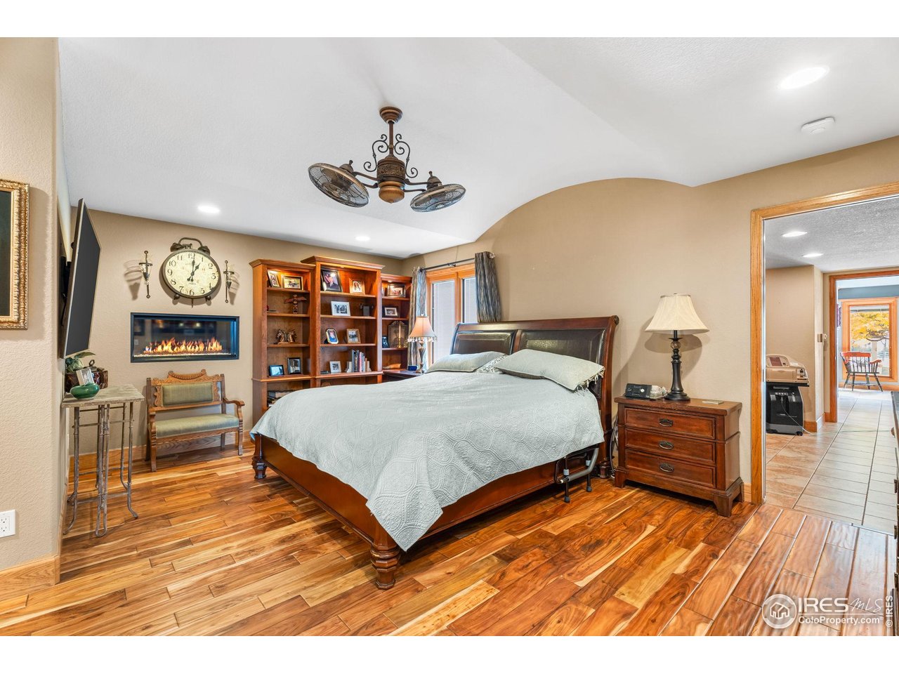 12625 Vermillion Road Longmont, CO 80504 - Photo 23 of 50 a bedroom with a large bed and a wooden floor