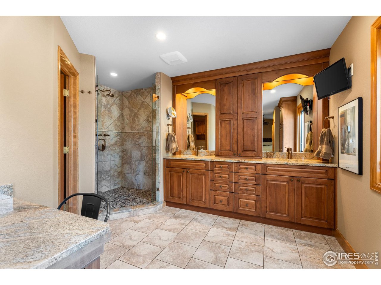 12625 Vermillion Road Longmont, CO 80504 - Photo 24 of 50 a bathroom with a granite countertop sink mirror and shower