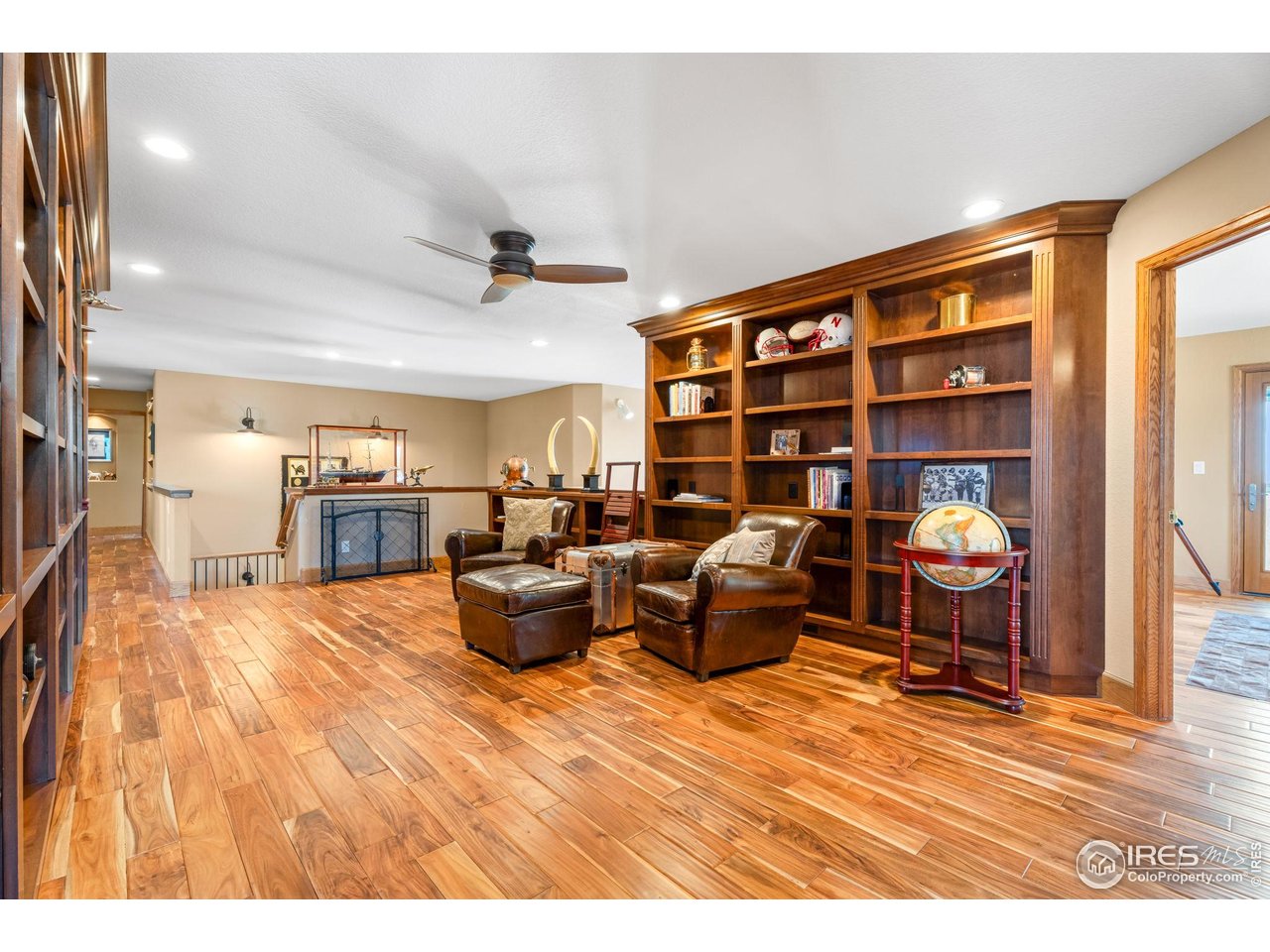 12625 Vermillion Road Longmont, CO 80504 - Photo 26 of 50 a living room with furniture kitchen view and a wooden floor