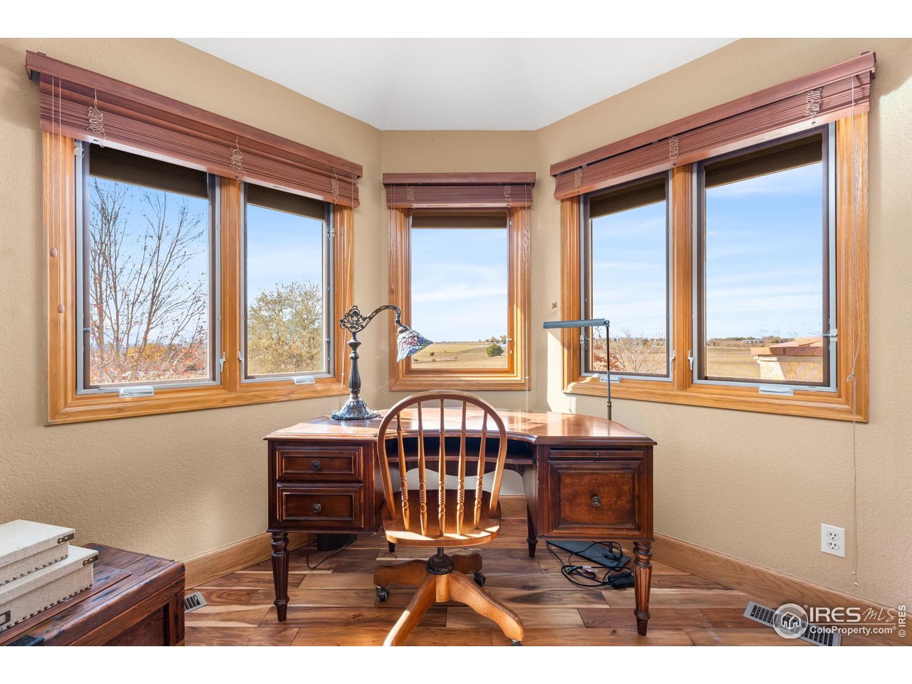 12625 Vermillion Road Longmont, CO 80504 - Photo 28 of 50 a view of a dining room with furniture a chandelier and wooden floor