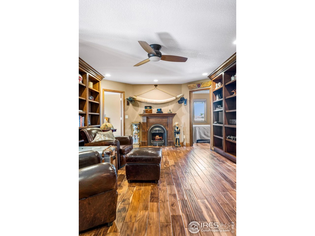 12625 Vermillion Road Longmont, CO 80504 - Photo 30 of 50 a living room with furniture and a fireplace