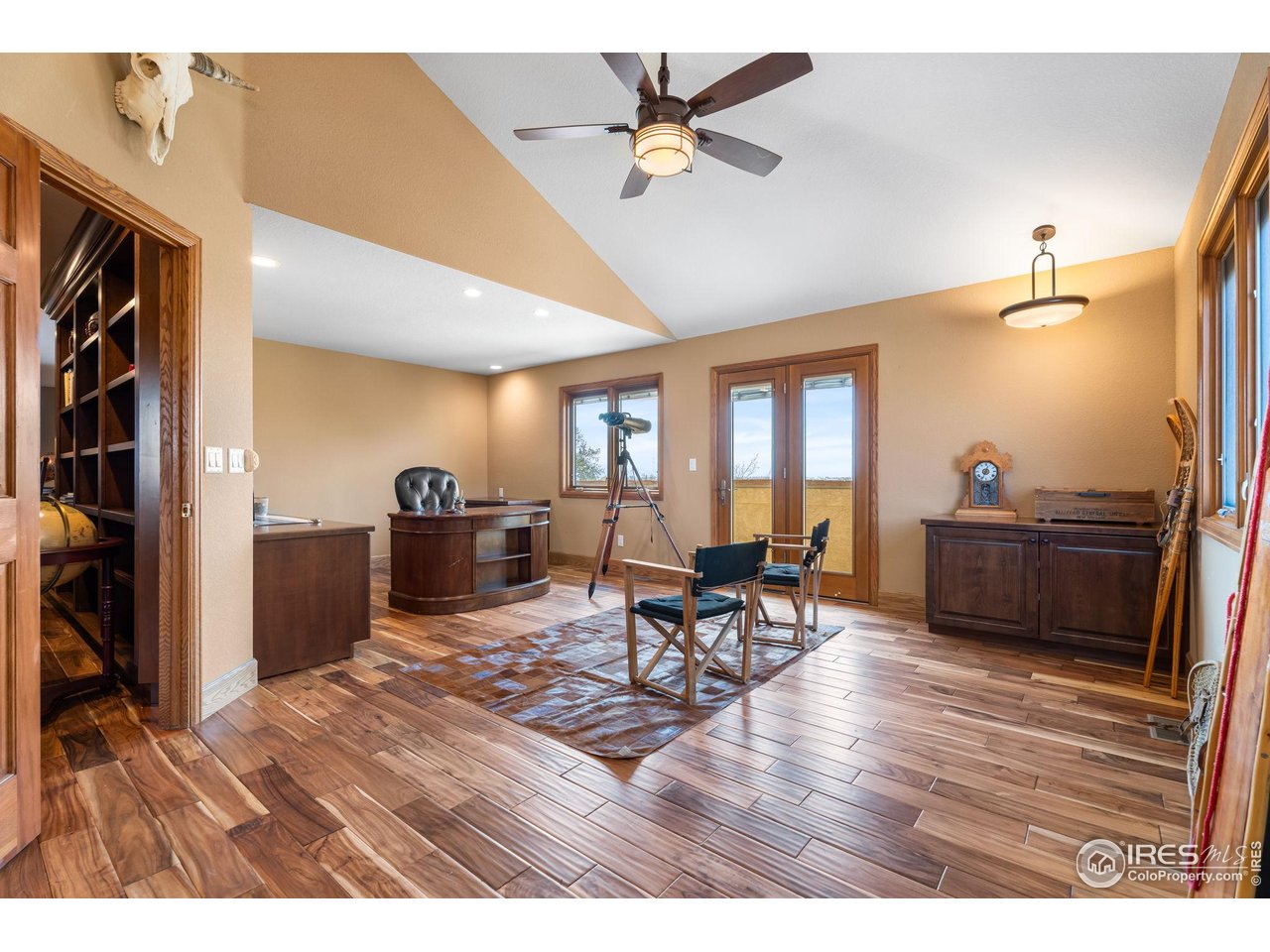 12625 Vermillion Road Longmont, CO 80504 - Photo 31 of 50 a living room with furniture a flat screen tv and a table