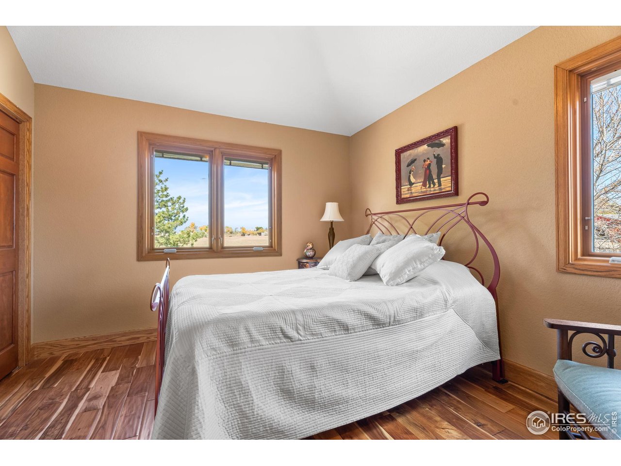 12625 Vermillion Road Longmont, CO 80504 - Photo 34 of 50 a bedroom with a bed and a painting on the wall