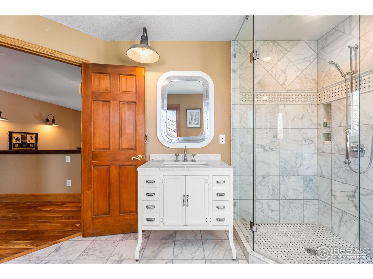 12625 Vermillion Road Longmont, CO 80504 - Photo 35 of 50 a bathroom with a sink a mirror and a shower
