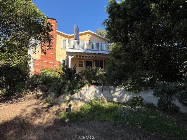 a view of a house with a yard and tree s