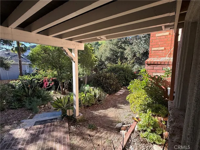 a view of backyard with plants and outdoor seating