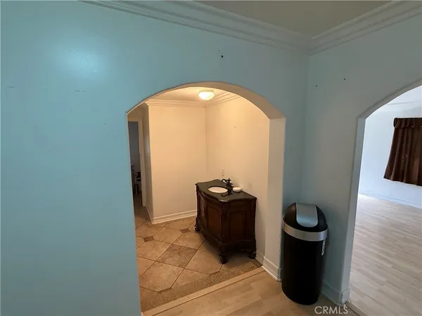 a view of a hallway with wooden floor and a mirror