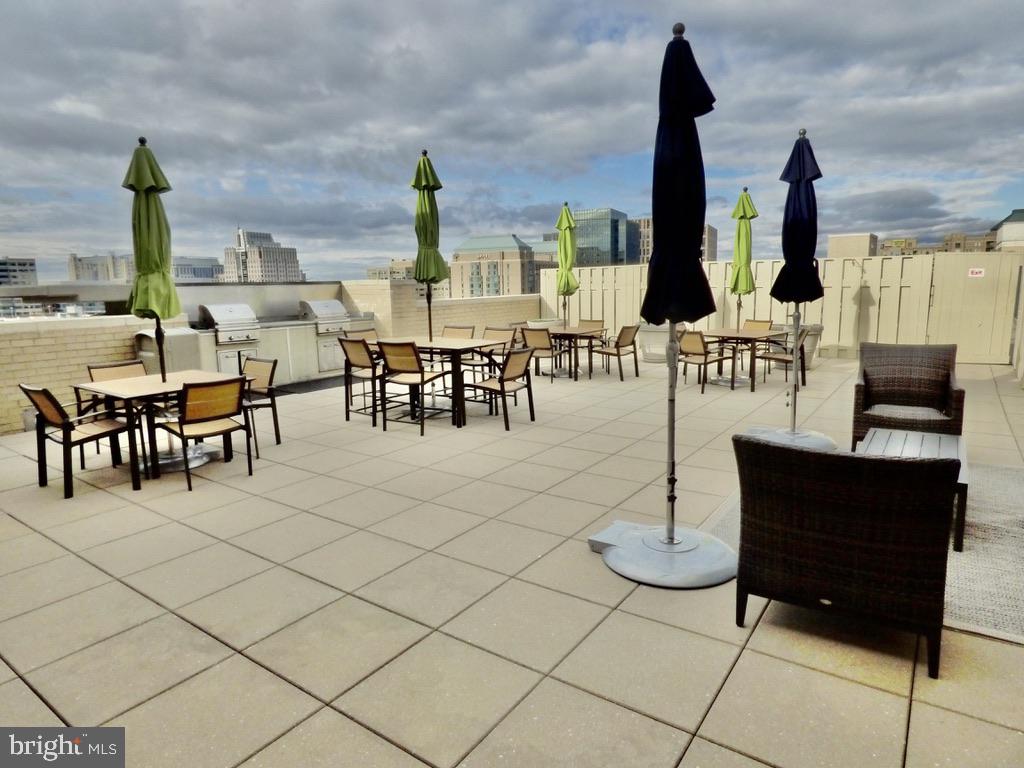 11800 Sunset Hills Road, Unit 118 Reston, VA 20190 - Photo 49 of 52 Rooftop retreat with vibrant umbrellas.