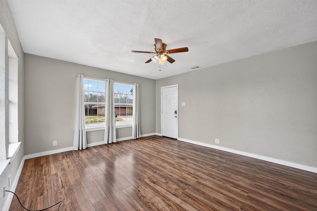 205 South Mable Street Ferris, TX 75125 - Photo 11 of 31 wooden floor in an empty room with a window