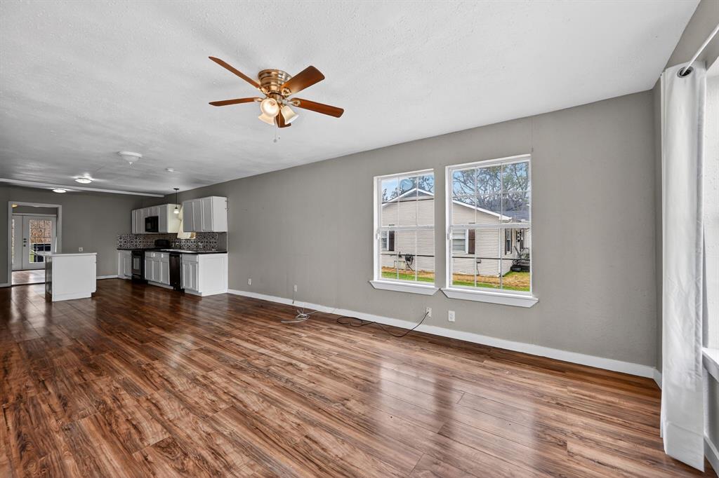 205 South Mable Street Ferris, TX 75125 - Photo 12 of 31 a view of an empty room with window and wooden floor