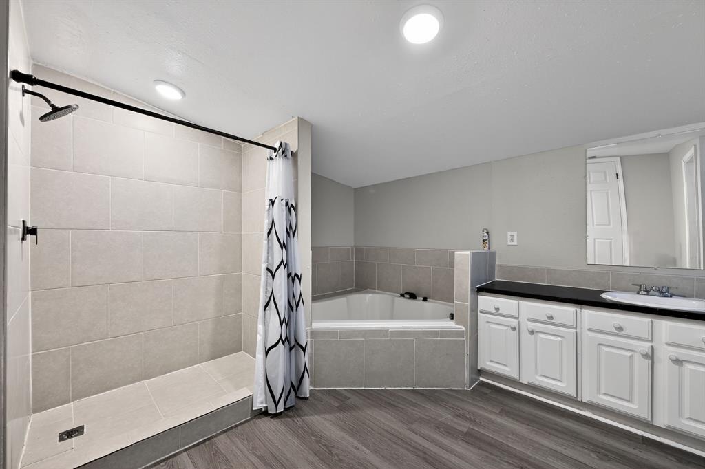 205 South Mable Street Ferris, TX 75125 - Photo 20 of 31 a bathroom with a bathtub and a shower