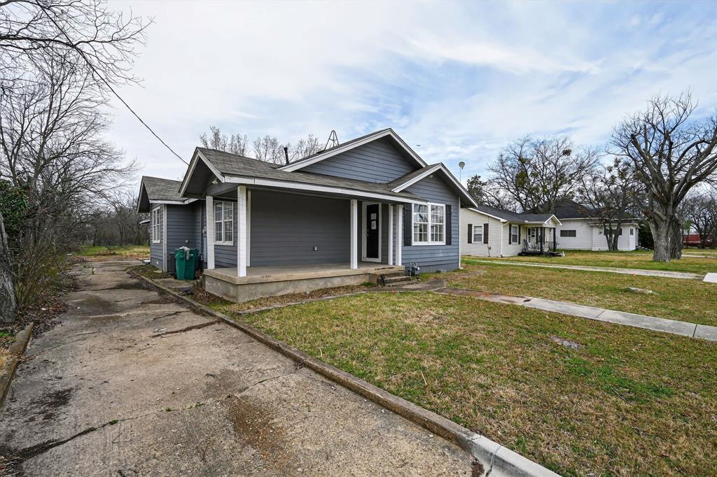 205 South Mable Street Ferris, TX 75125 - Photo 2 of 31 a front view of a house with garden