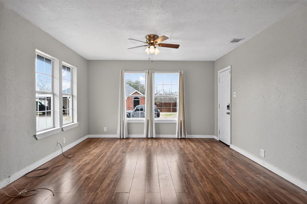 205 South Mable Street Ferris, TX 75125 - Photo 8 of 31 a view of empty room with wooden floor and fan