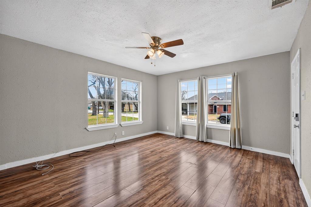205 South Mable Street Ferris, TX 75125 - Photo 10 of 31 a view of an empty room with a window and wooden floor