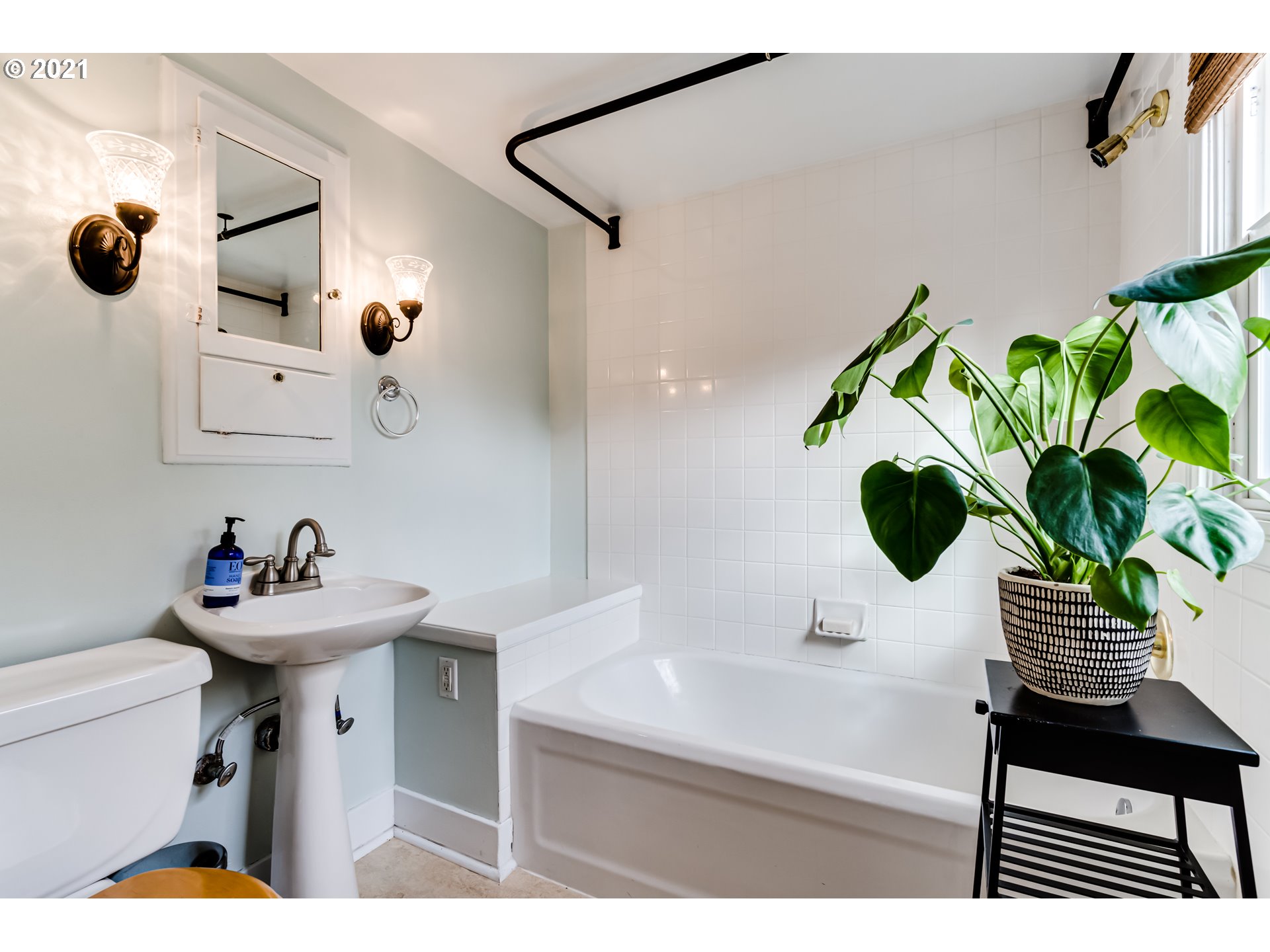1823 Lincoln Street Eugene, OR 97401 - Photo 22 of 32 a bathroom with a sink a mirror and a potted plant