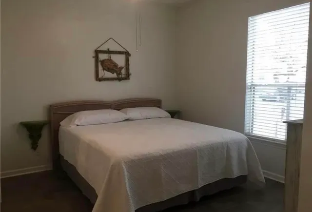 a bedroom with a bed and a window