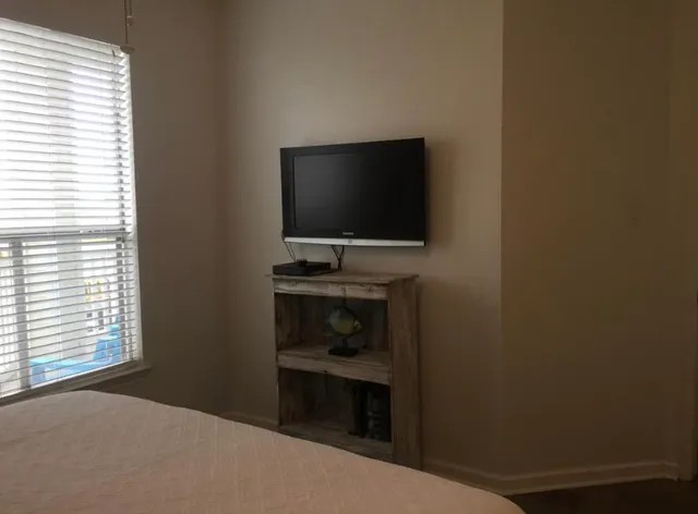 a bedroom with a bed and a flat screen tv