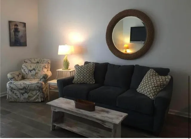 a living room with furniture and a mirror