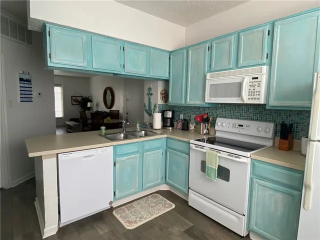 a kitchen with stainless steel appliances granite countertop a sink and cabinets