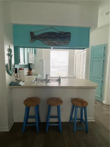 a kitchen with a table chairs sink and cabinets