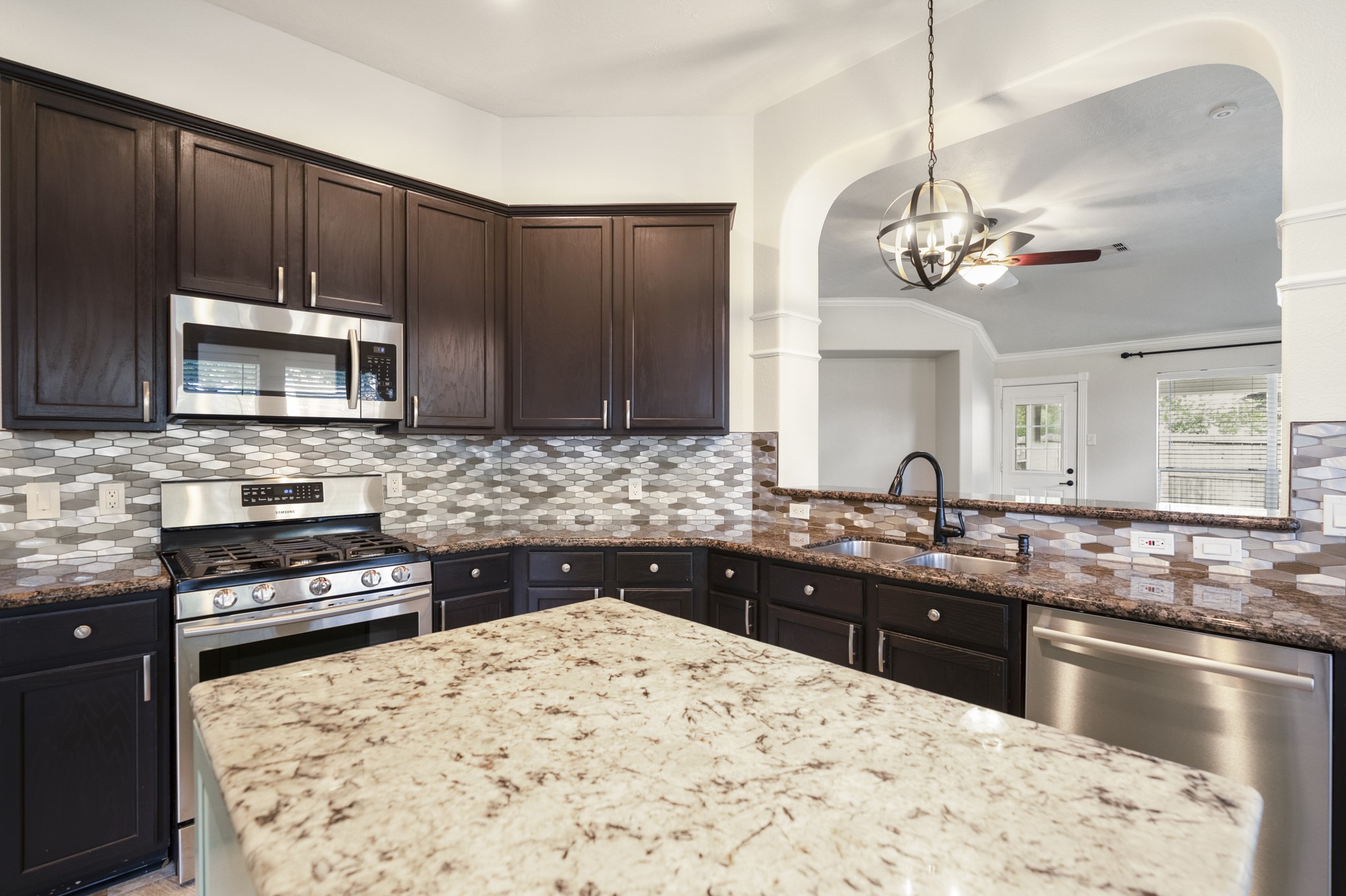 5802 Sawyer Bend Lane Spring, TX 77379 - Photo 10 of 50 a kitchen with stainless steel appliances granite countertop a sink stove and microwave