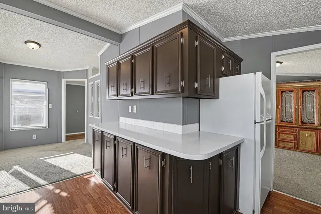 a kitchen with a sink cabinets and wooden floor