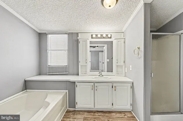 a bathroom with a tub a sink and a window
