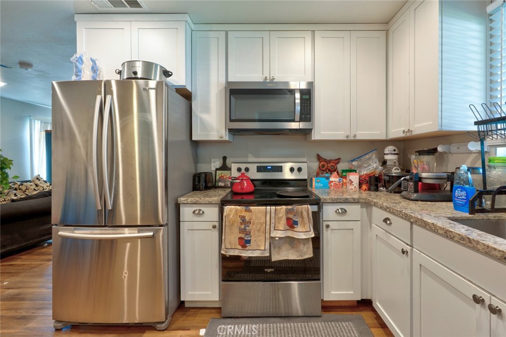1840 Cheyenne Drive Merced, CA 95348 - Photo 23 of 90 a kitchen with a refrigerator sink and microwave