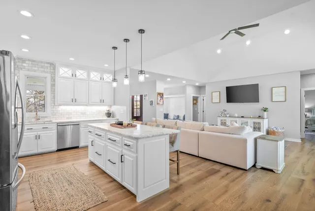 a very nice looking room with a large window and furniture