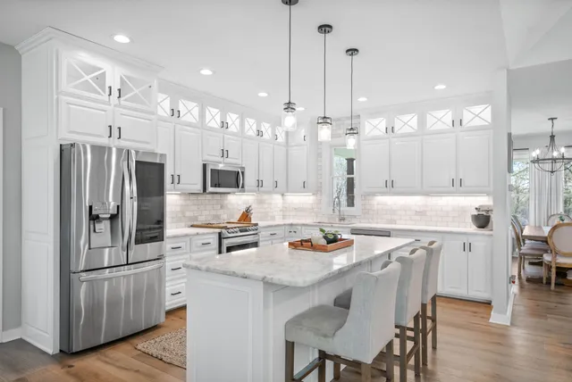 a kitchen with cabinets appliances and a sink