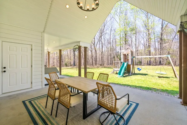 a view of a house with a backyard and sitting area