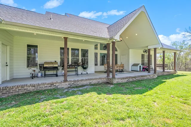 a view of open space with huge green field and large trees