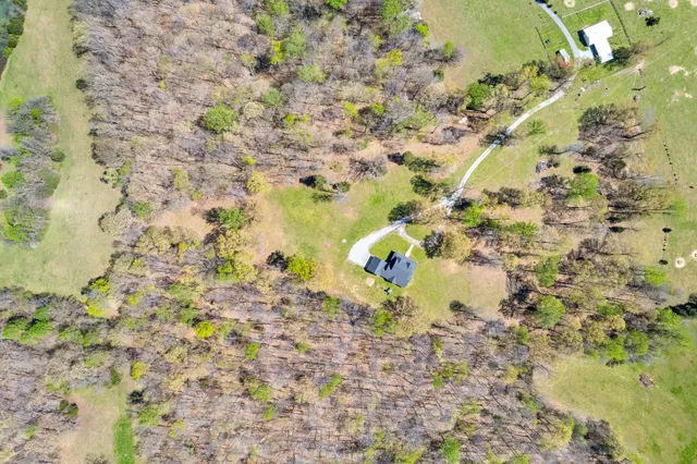 a view of a field with a house in the background