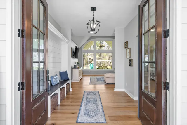 a living room with furniture a large window and a flat screen tv