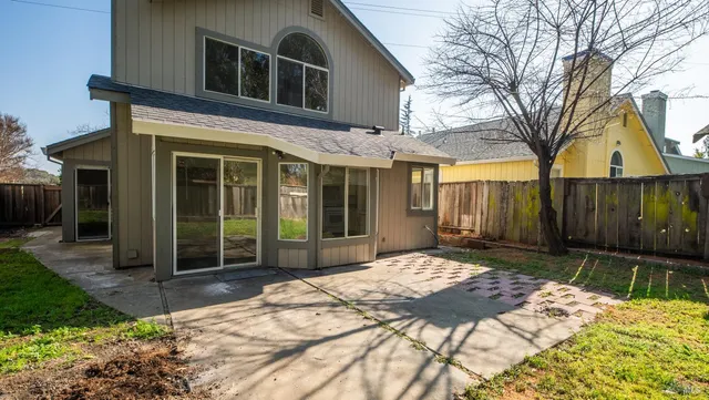 a front view of a house with a yard table and chairs