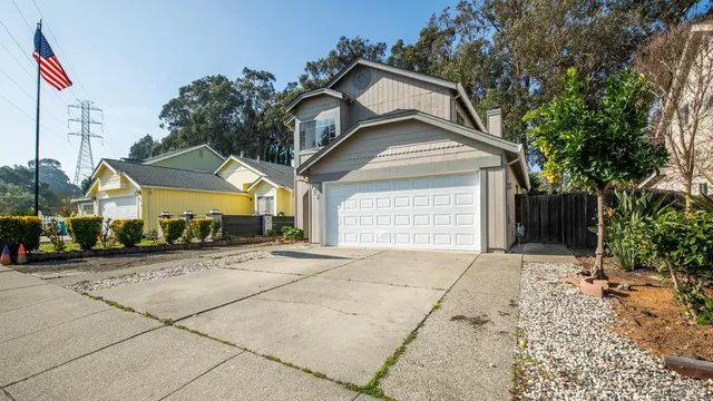 a front view of a house with a yard and garage