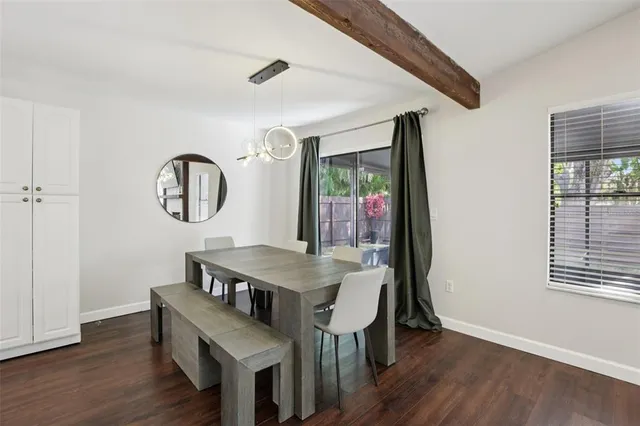 a view of a dining room with furniture and a window