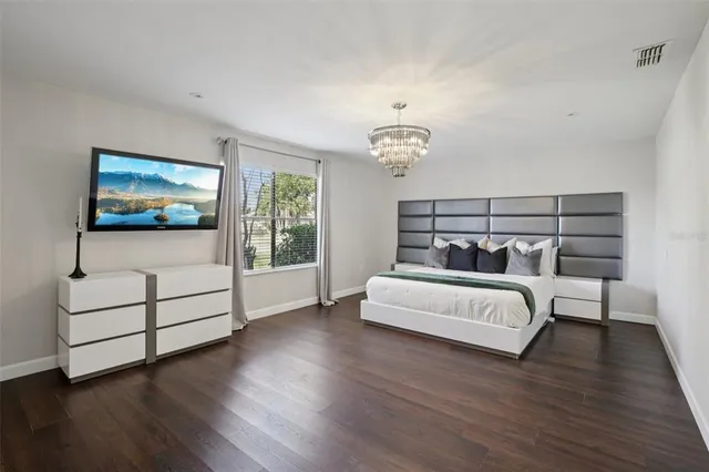 a view of a bedroom with furniture and wooden floor