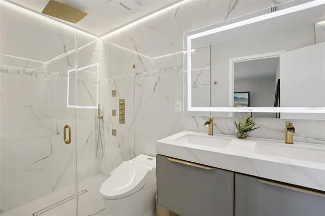 a bathroom with a sink toilet and shower