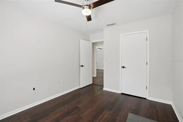 a view of a room with wooden floor