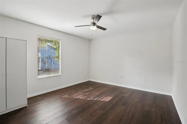 wooden floor in an empty room with a window