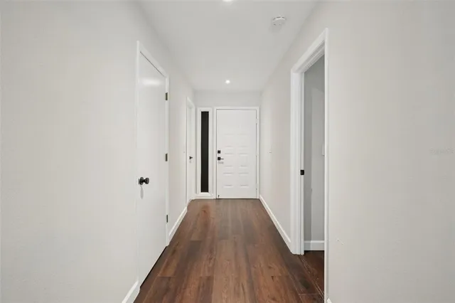 a view of a hallway with wooden floor