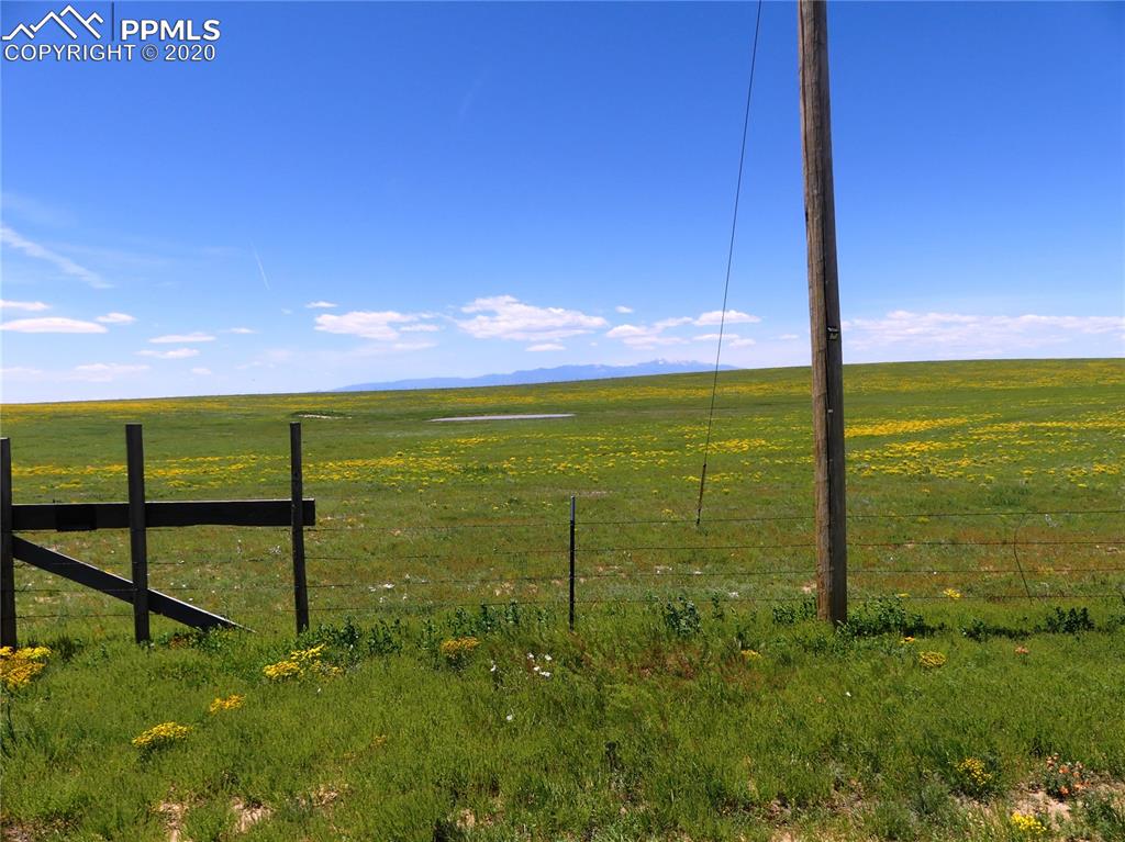 30150 Antioch Road Yoder, CO 80864 - Photo 29 of 36 From Antioch Road at east edge of property looking west. Pikes Peak and runoff pond in distance