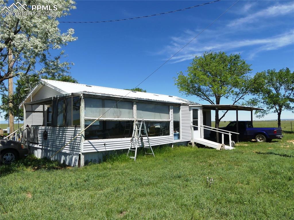 30150 Antioch Road Yoder, CO 80864 - Photo 5 of 36 Enclosed porch and Carport (east)